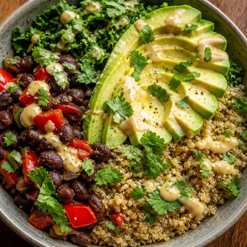 Vegan quinoa black bean bowl with fresh vegetables and herbs